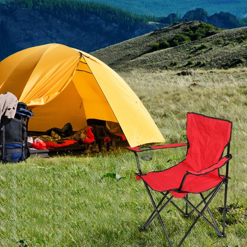 Roter Campingstuhl mit Getränkehalter vor einem Zelt auf einer Wiese.