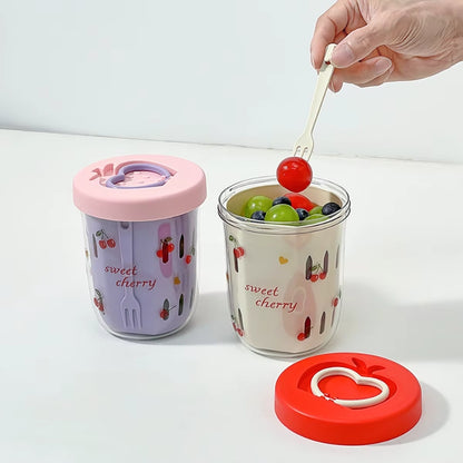 Anwendung des Sweet-Cherry-Salatbechers mit frischem Obst, integrierte Gabel im Einsatz, Deckel daneben abgelegt.